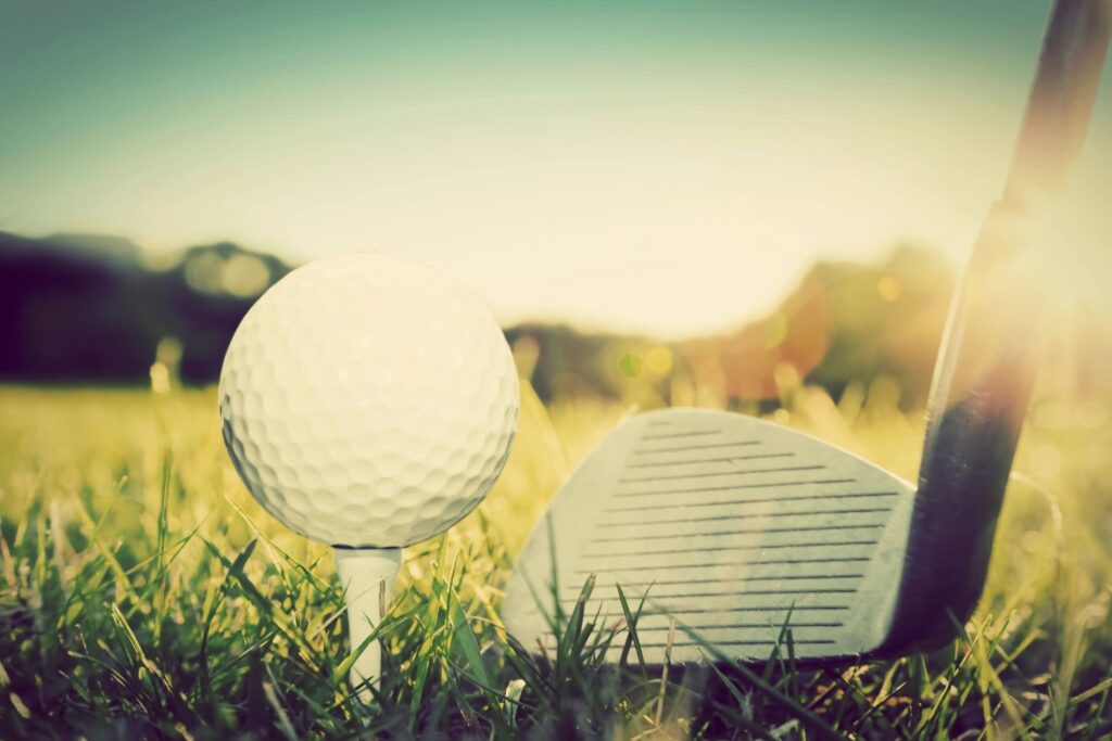 golf club and tee with white ball